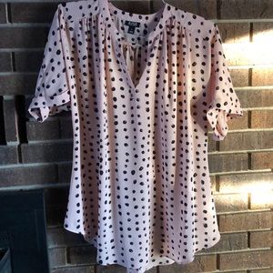 Short sleeve pink with black polka dots.
